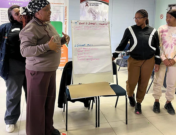A facilitator with participants at the Emthonjeni workshop